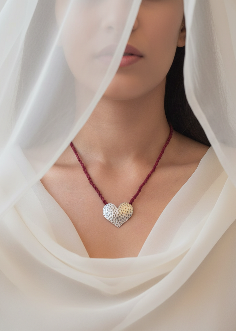 Woman wearing a heart-shaped necklace with a white veil